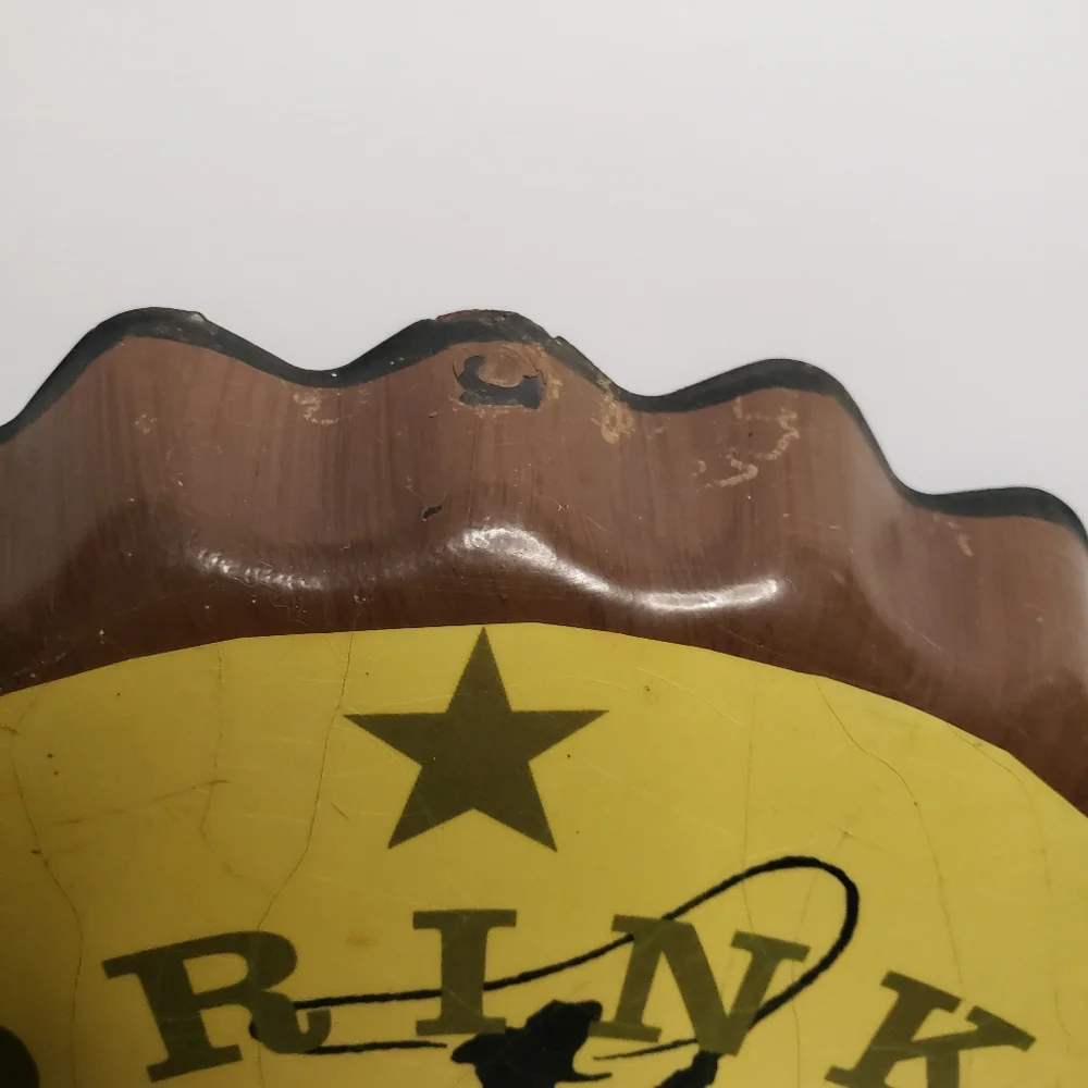 Metal Cowboy clock shaped like bottle cap. 191